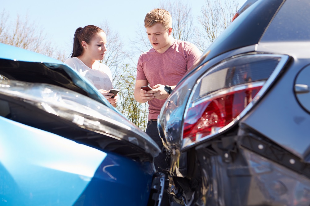 Two drivers talking about the car accident they are involved in.