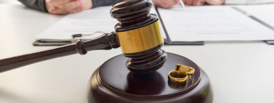 judge's gavel and wedding rings