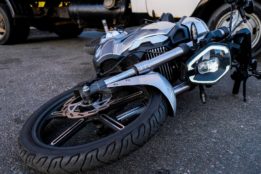 motorcycle laying on the ground after a motorcycle accident