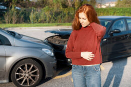 young woman holding her neck after a head-on collision