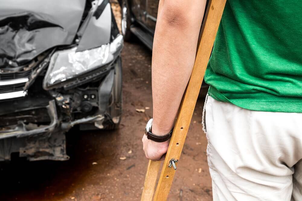 Driver involved in car accident walking with crutches.