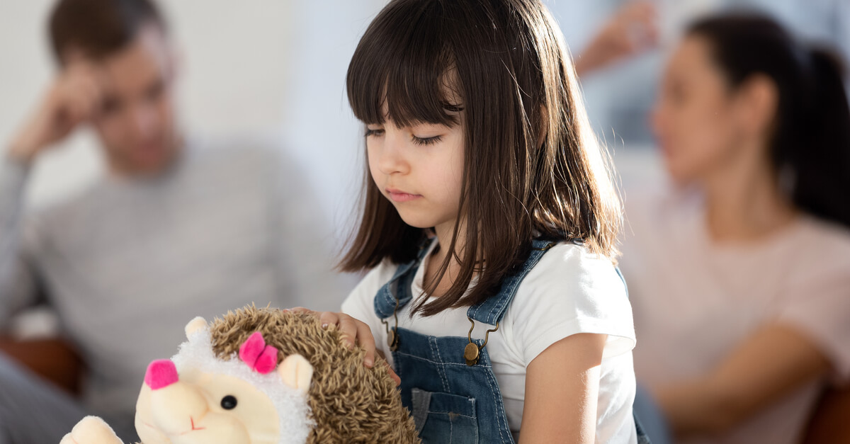 Little girl feeling down because of her parents.