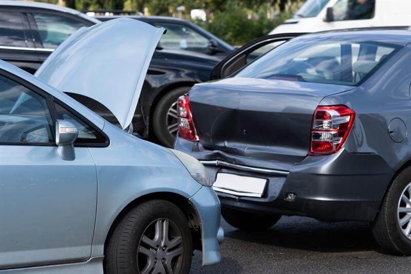 Accident on the street, damaged sedan cars after a collision in the city.