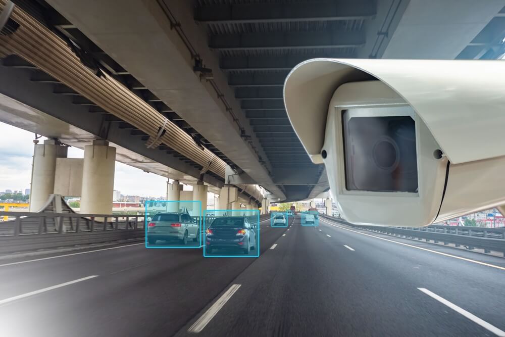Road traffic camera films passing cars.