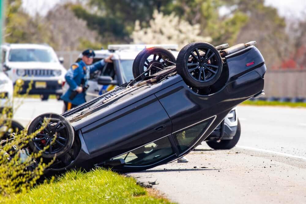 Car rollover in the highway with police investigating.